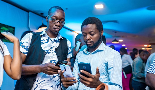 Mister Mobility and wale Oladipupo examining the OPPO Reno2 device at the launch