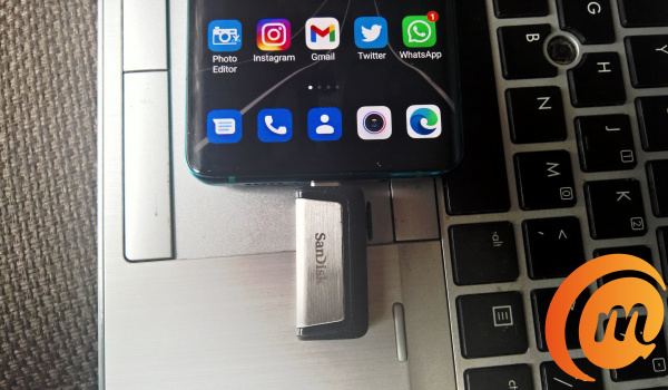 SanDisk Ultra 128GB dual flash drive plugged into phone