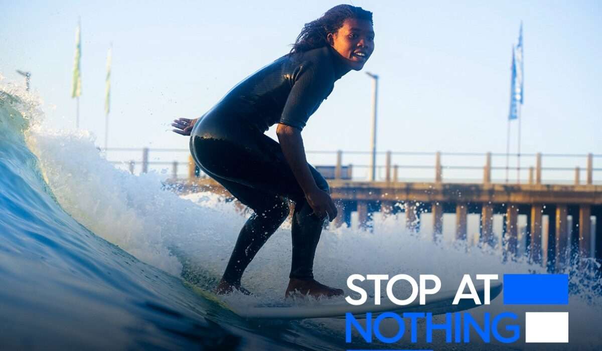 Stop At Nothing - A young black girl surfing a wave.