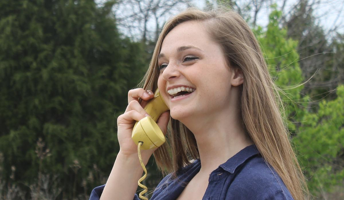 white woman making telephone call outdoors