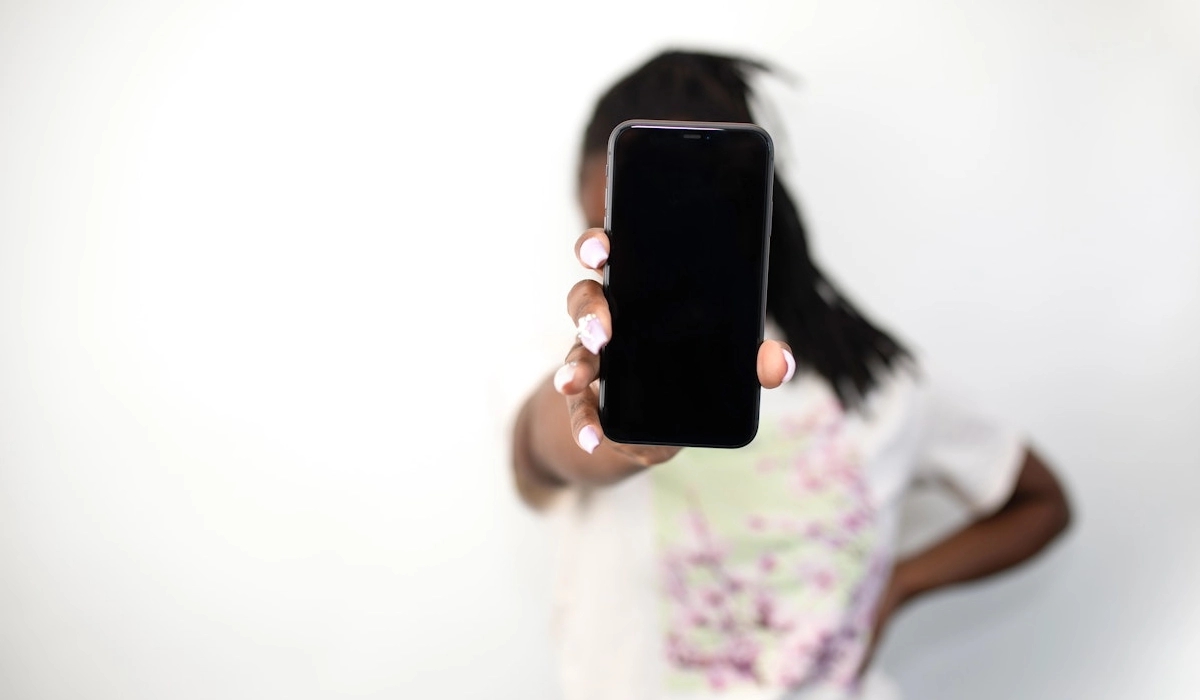 Girl holding up a phone